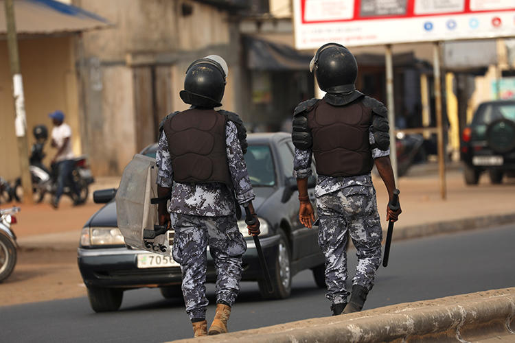Riot police officers patrol the street as they try to stop protesters from gathering in front of the College Saint Joseph in Lome